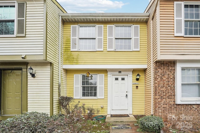 view of exterior entry featuring brick siding