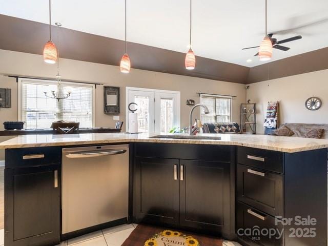 kitchen featuring a sink, open floor plan, hanging light fixtures, stainless steel dishwasher, and vaulted ceiling