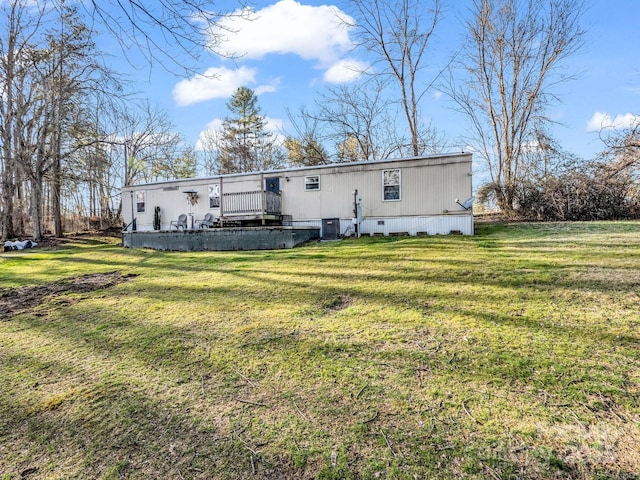 back of house with a lawn