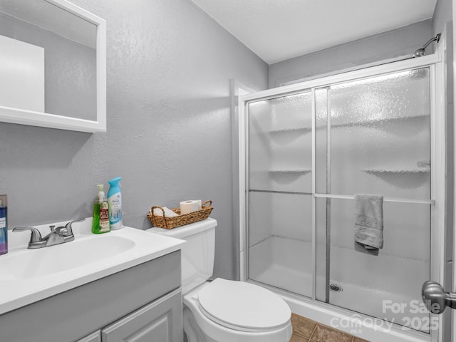 bathroom with vanity, an enclosed shower, and toilet