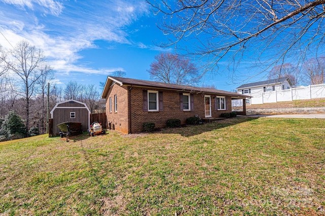 view of front of property with a front lawn and a shed