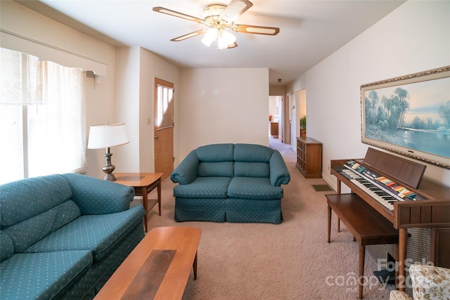 carpeted living room with visible vents and ceiling fan