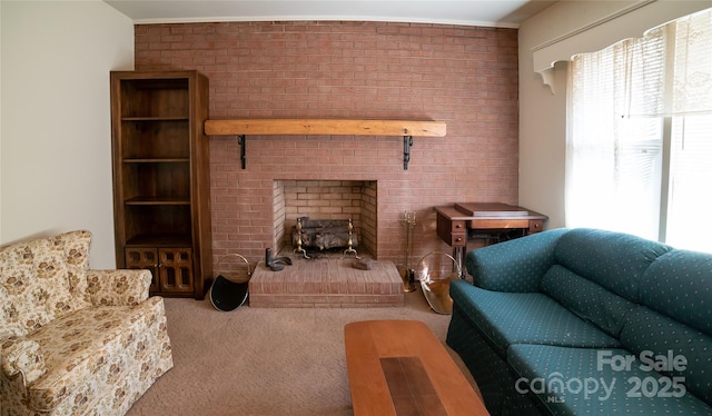 living room with plenty of natural light, a brick fireplace, brick wall, and carpet floors