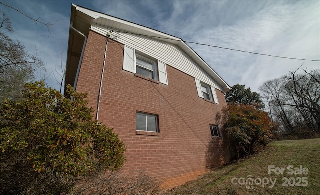 view of side of property featuring brick siding