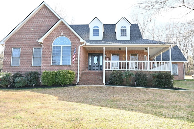 view of front of property with a front yard and covered porch