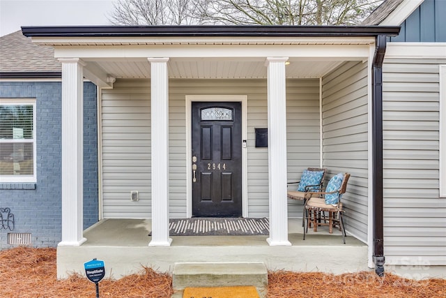 view of exterior entry with a porch