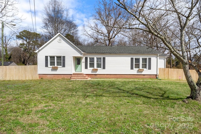 view of front of property featuring entry steps, a front yard, and fence