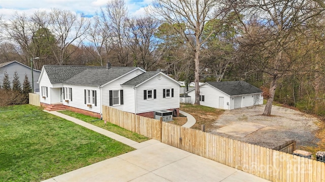 single story home with a fenced front yard, a front yard, roof with shingles, a chimney, and an outdoor structure