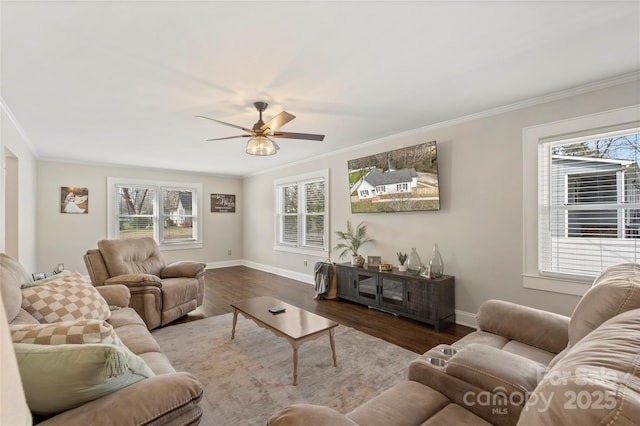 living room featuring plenty of natural light, wood finished floors, and crown molding