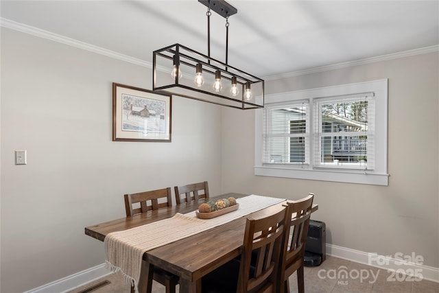 dining area featuring baseboards and ornamental molding