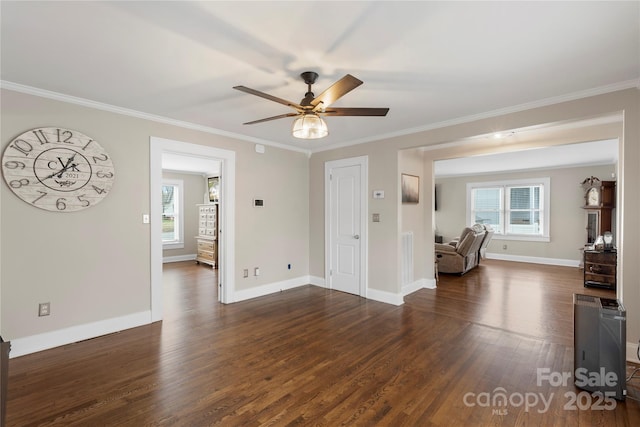 unfurnished living room featuring crown molding, dark wood-type flooring, and baseboards