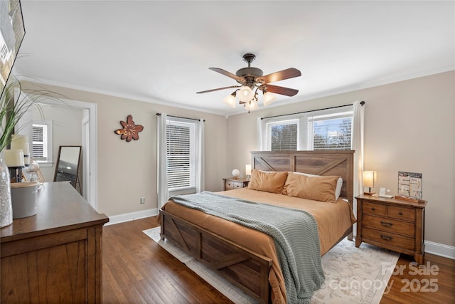 bedroom with ceiling fan, crown molding, dark wood-type flooring, and baseboards