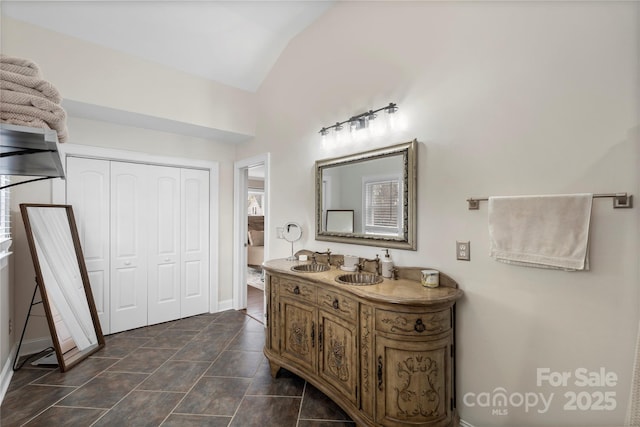 bathroom featuring tile patterned floors, vanity, and lofted ceiling