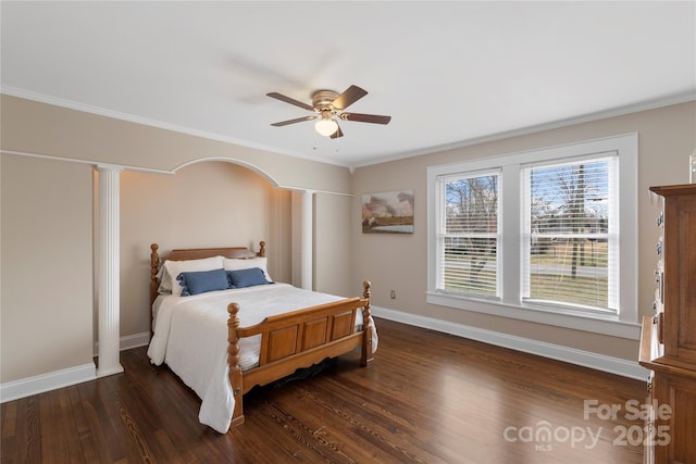 bedroom with dark wood-style floors, baseboards, and ornamental molding