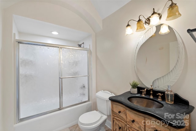 full bathroom featuring enclosed tub / shower combo, toilet, and vanity