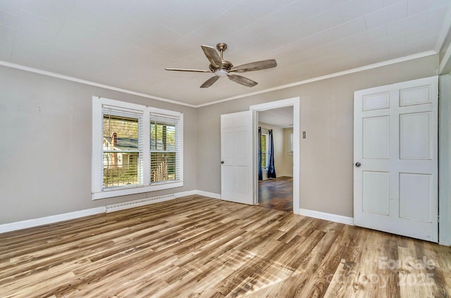 unfurnished room with wood finished floors, ornamental molding, baseboards, a ceiling fan, and baseboard heating