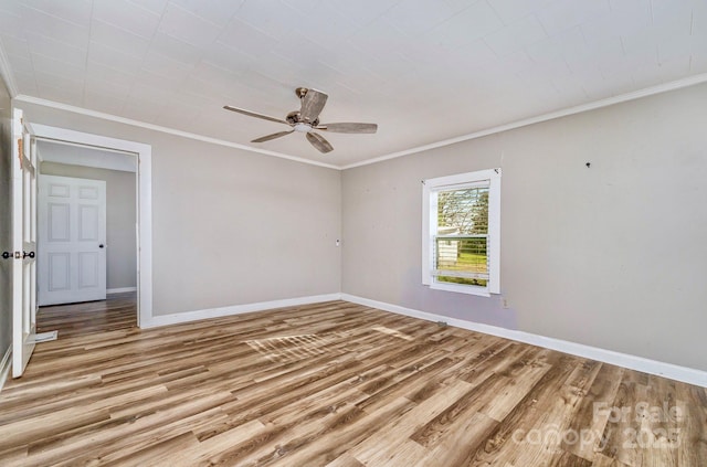 empty room featuring a ceiling fan, baseboards, and light wood-type flooring