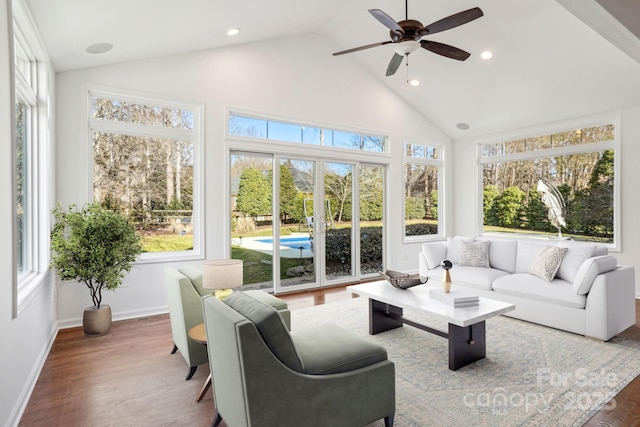 sunroom / solarium featuring lofted ceiling and ceiling fan