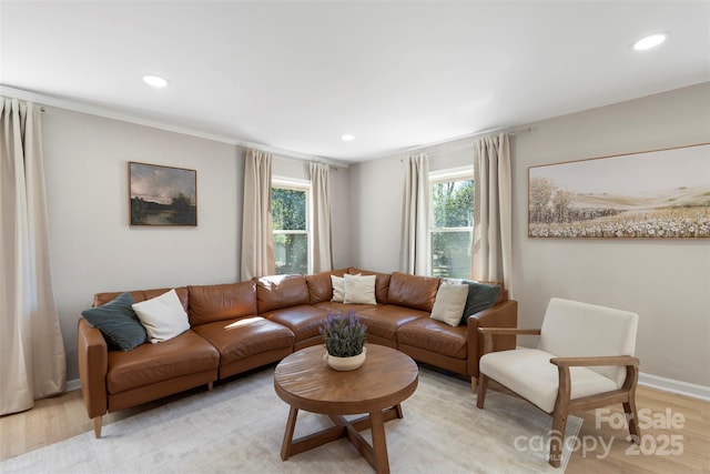 living area with recessed lighting, light wood-style flooring, and baseboards