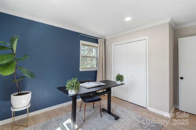 home office featuring crown molding, baseboards, and wood finished floors