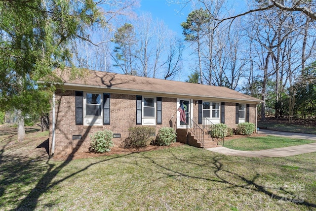 single story home with roof with shingles, brick siding, crawl space, and a front yard