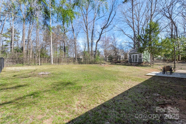 view of yard with a storage shed, a fenced backyard, a patio, and an outdoor structure