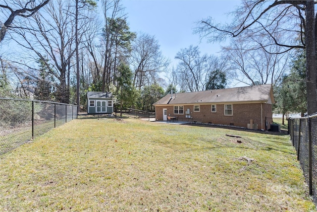 view of yard with an outbuilding, a storage shed, central AC unit, a patio area, and a fenced backyard