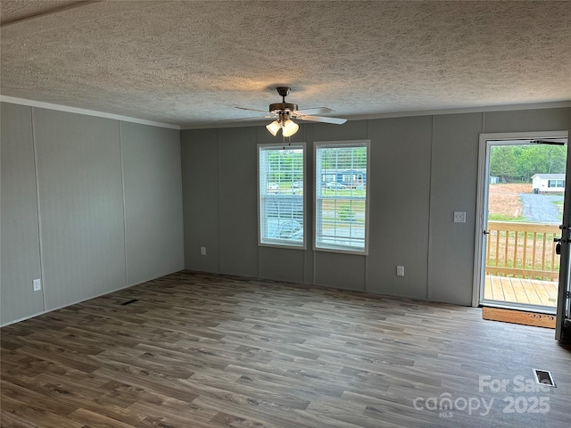252 Fairchase Cir Unit 56, Stony Point, NC 28678 - unfurnished room with a decorative wall, wood finished floors, a ceiling fan, and a textured ceiling