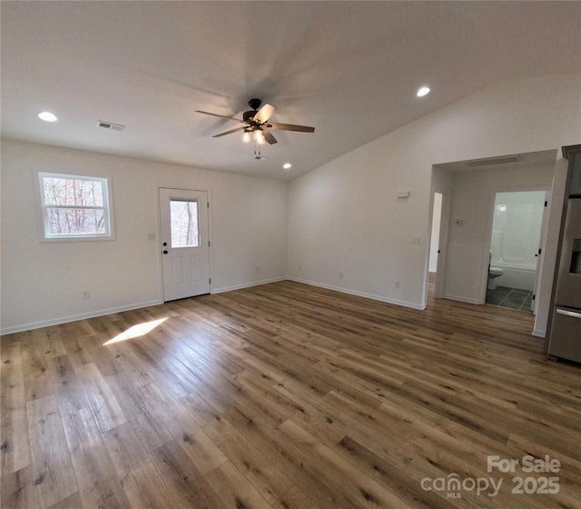 unfurnished living room with dark wood-type flooring, ceiling fan, and lofted ceiling