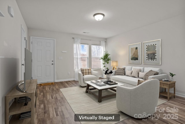 living room featuring baseboards and wood finished floors