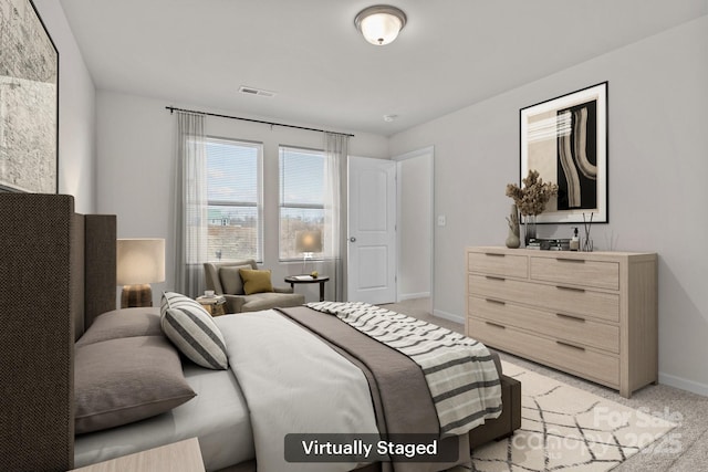 bedroom featuring light carpet, visible vents, and baseboards