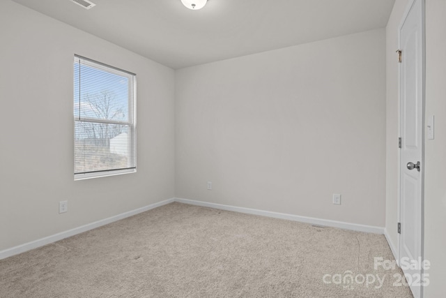 carpeted spare room with baseboards