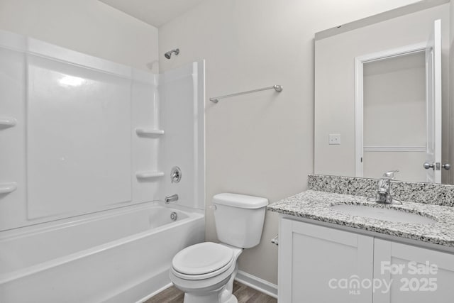 full bathroom featuring toilet, wood finished floors, vanity, baseboards, and shower / washtub combination