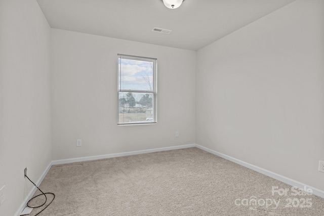 unfurnished room featuring baseboards, visible vents, and carpet flooring