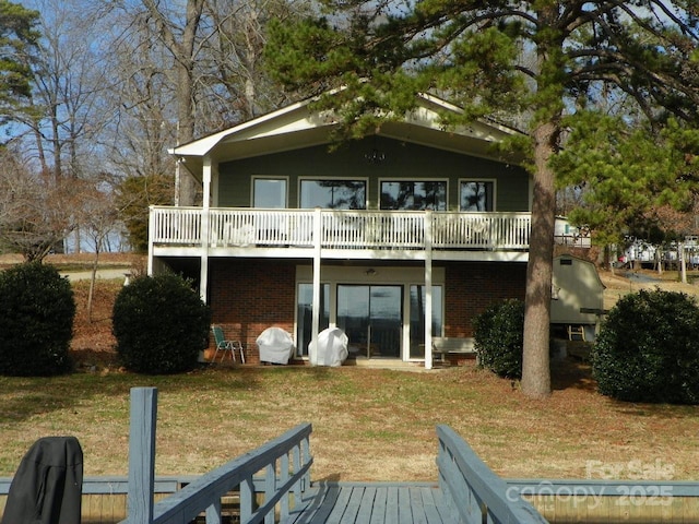 back of house with a yard and a deck