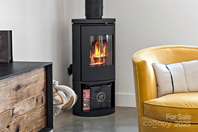 interior details featuring a wood stove and concrete floors