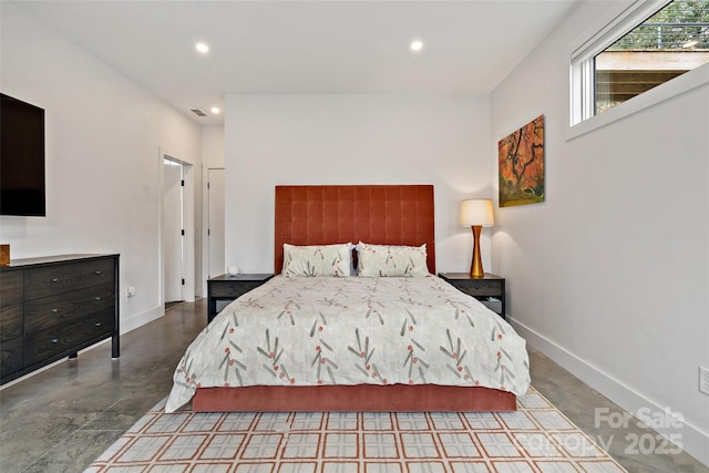 bedroom with finished concrete floors, recessed lighting, and baseboards