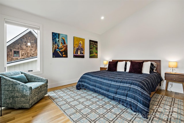 bedroom with lofted ceiling, baseboards, wood finished floors, and recessed lighting