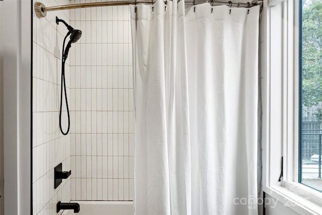 bathroom featuring shower / tub combo with curtain