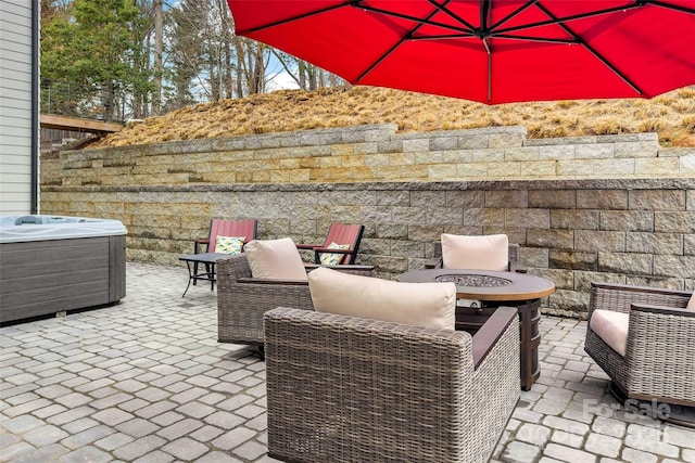 view of patio / terrace with central air condition unit and an outdoor fire pit