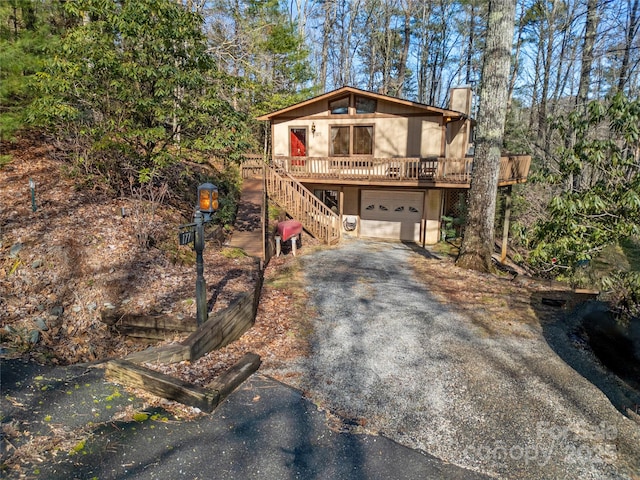 front of property featuring a wooden deck and a garage