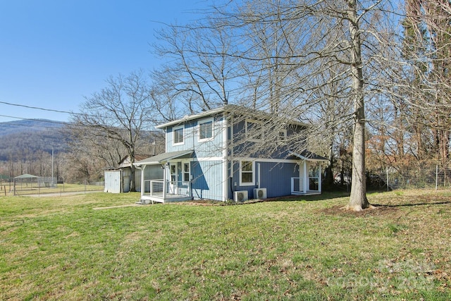 back of property featuring a yard and fence