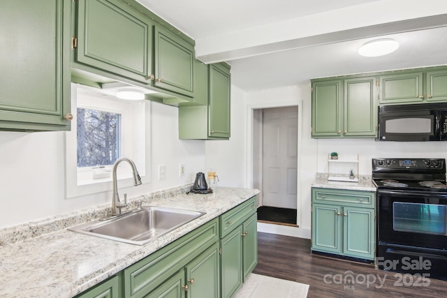 kitchen with a sink, black appliances, light countertops, dark wood-type flooring, and green cabinets