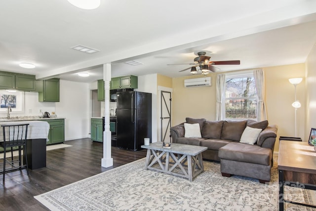 living area featuring a wall mounted air conditioner, visible vents, dark wood-style floors, and ceiling fan