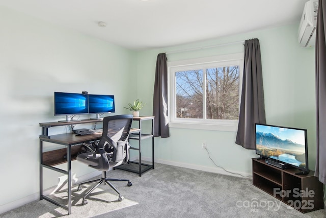 office area with a wall unit AC, carpet, and baseboards