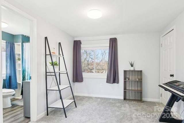 carpeted bedroom featuring baseboards