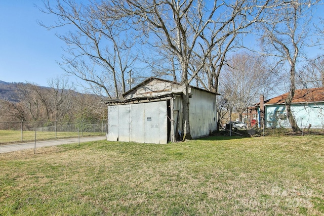 view of shed featuring fence and a mountain view