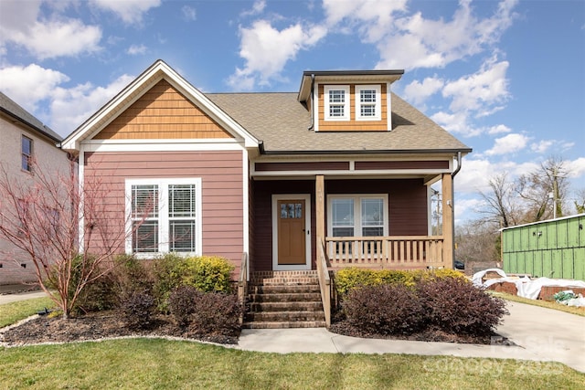 view of front of house with a porch and roof with shingles