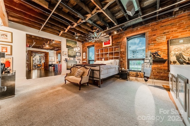 bedroom with brick wall and carpet floors