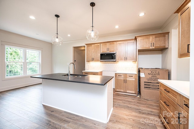 0 6th St NW, Hickory, NC 28601 - kitchen with a sink, stainless steel microwave, crown molding, tasteful backsplash, and light wood-type flooring